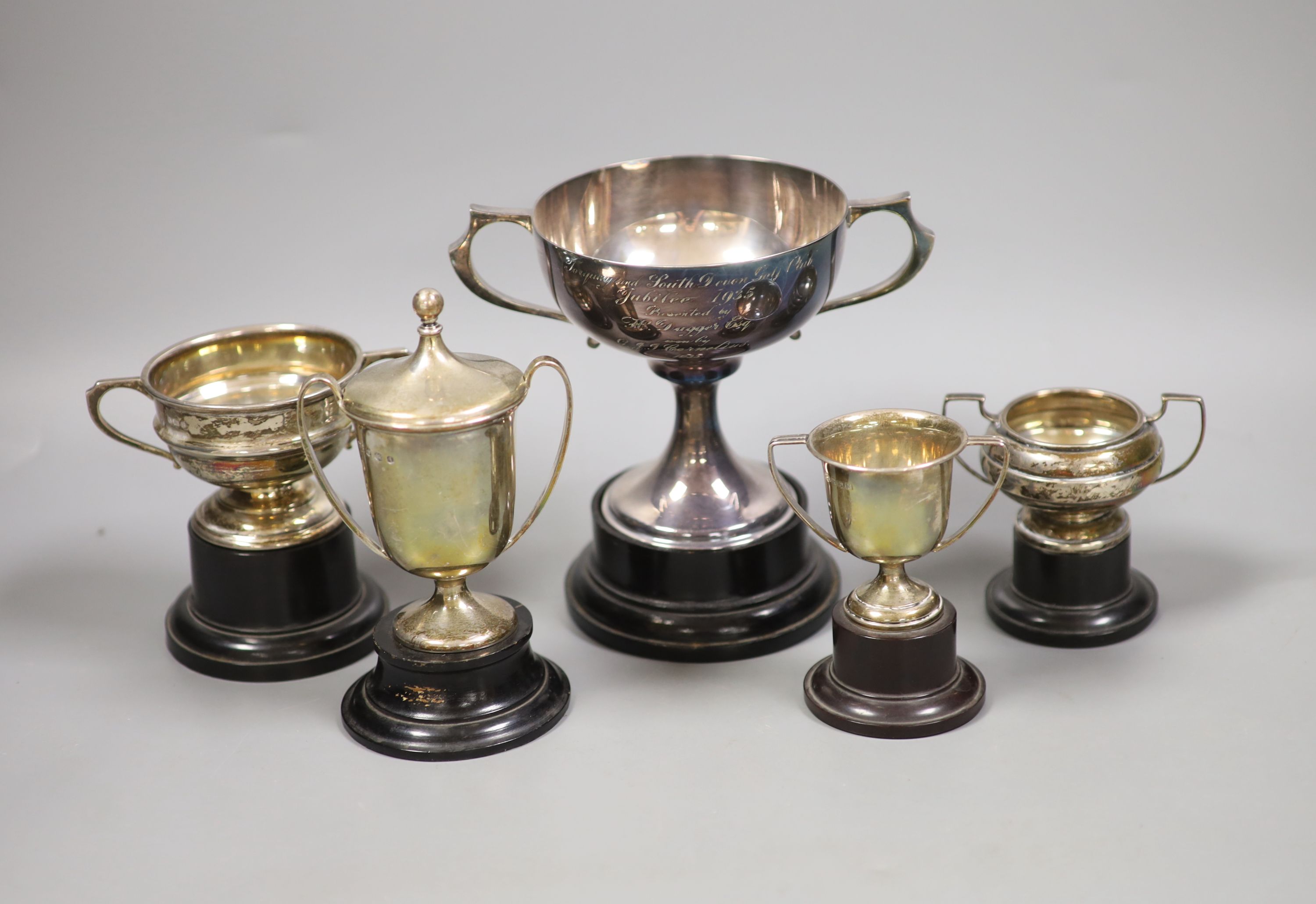 A collection of five small silver presentation trophy cups